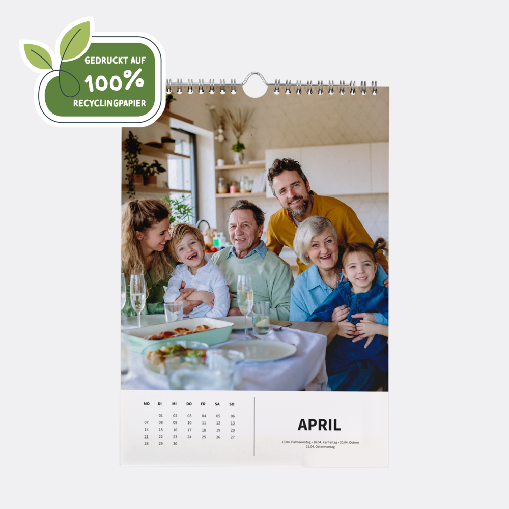Kalender im Format A4 hoch aus 100 % Recyclingpapier zeigt im April eine fröhliche Familie beim Mittagessen.